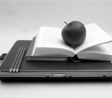 Lunch and Learn - photo of apple placed on top of a book and laptop